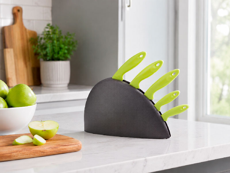 Set de cuchillos verdes colocado en encimera de cocina