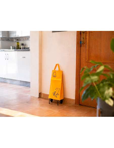 Carrito de la compra plegable color naranja en una cocina moderna.